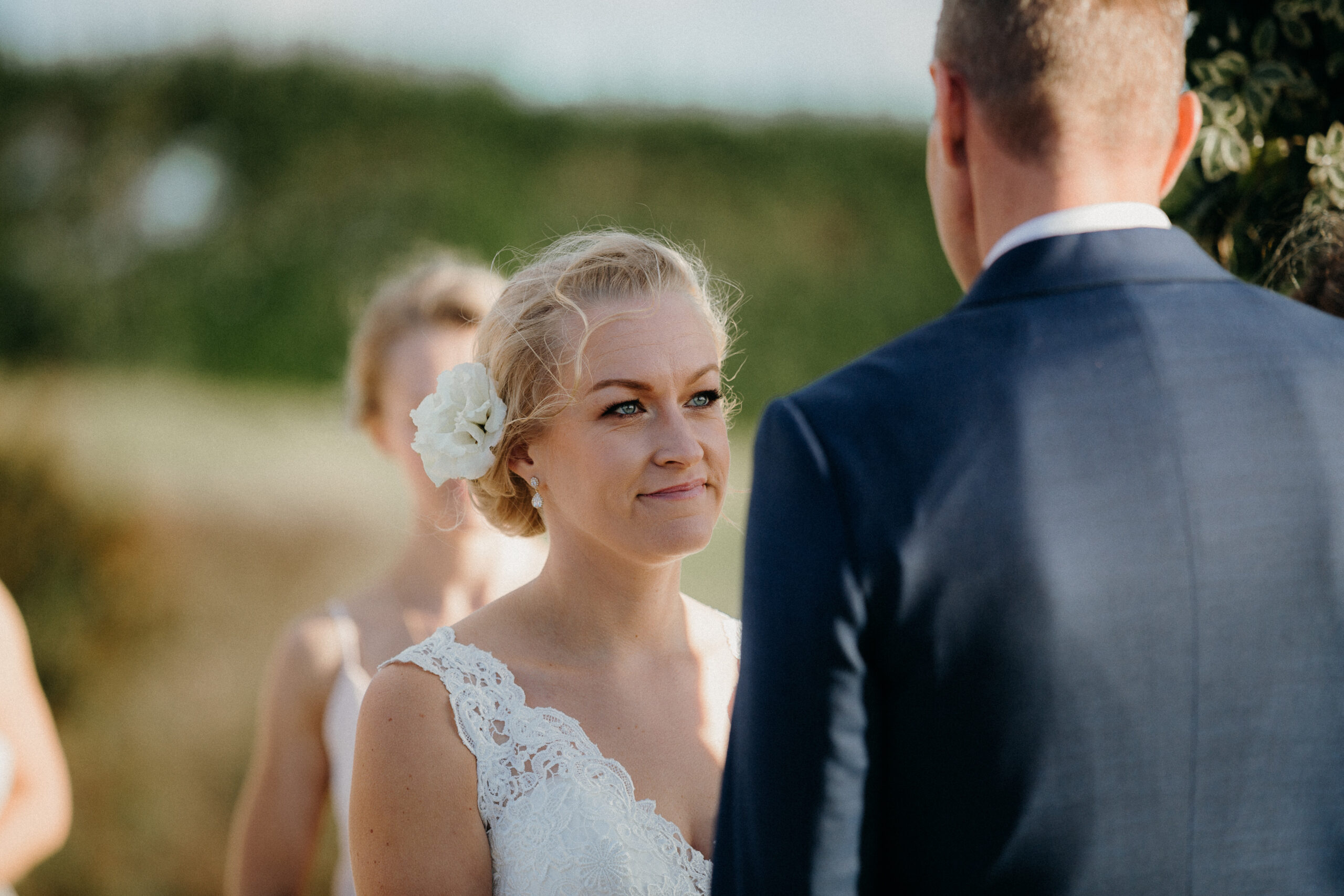Bride looking at groom during wedding ceremony at Mudbrick Lodge on Waiheke Island Auckland, photo by Sarah Weber Photography