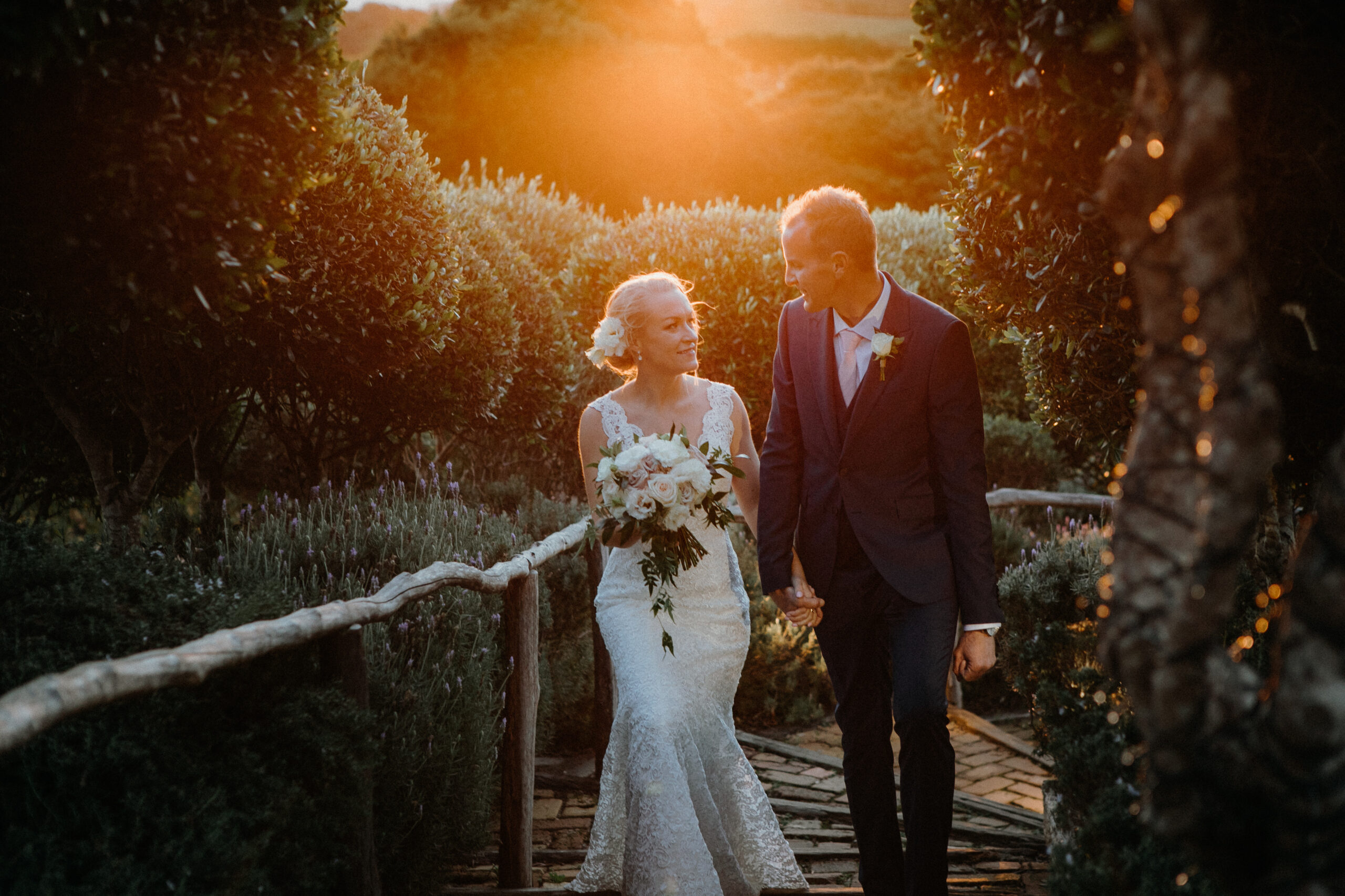 Bride and Groom wedding photos during sunset golden hour at Mudbrick Waiheke Island Auckland, by Sarah Weber Photography