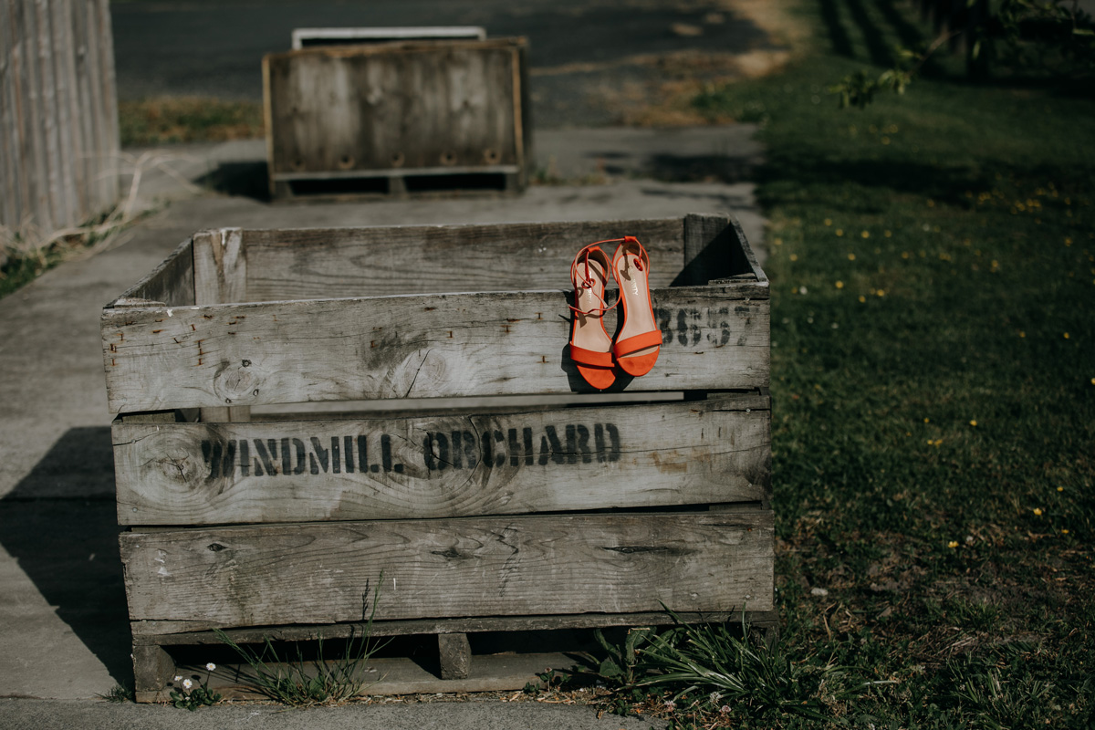 Auckland bride orange wedding shoes in Windmill Orchards from coatesville settlers hall