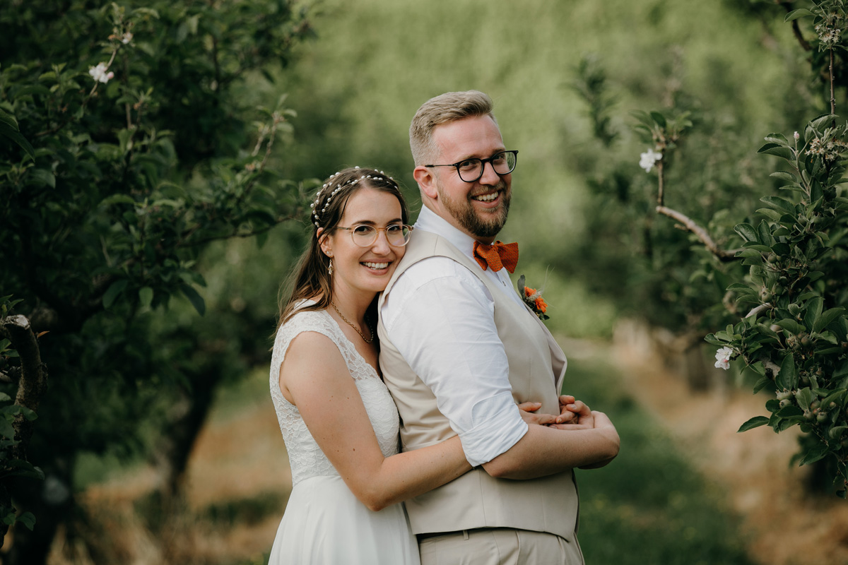 coatesville settlers hall wedding auckland bride and groom hug Windmill Orchards