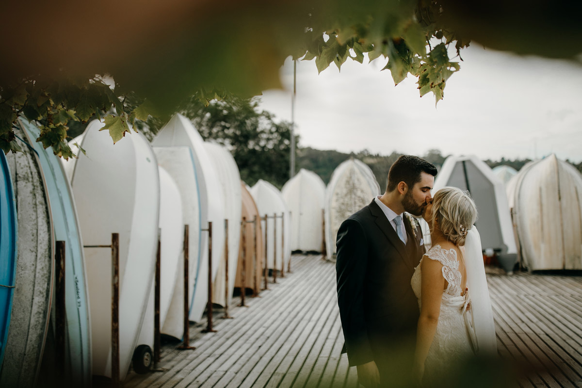 Bride and Groom kissing at Herald Island Wharf in Whenuapai, Auckland photo by Sarah Weber Photography
