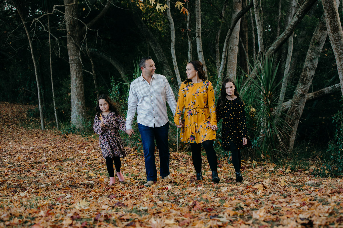 family walking in autumn fall leaves lifestyle portrait photoshoot session in west auckland. Photos by sarah weber photography