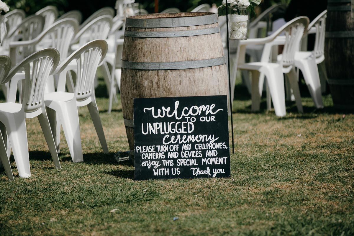 unplugged garden wedding ceremony sign at bridgewater country estate venue in Kaukapakapa, Auckland photo by sarah weber photography