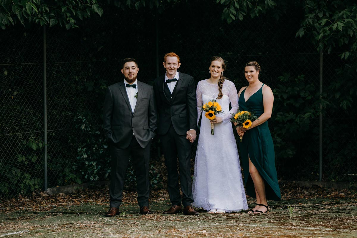 bridal party creative photos on old tennis court at bridgewater country estate venue in Kaukapakapa, Auckland photo by sarah weber photography