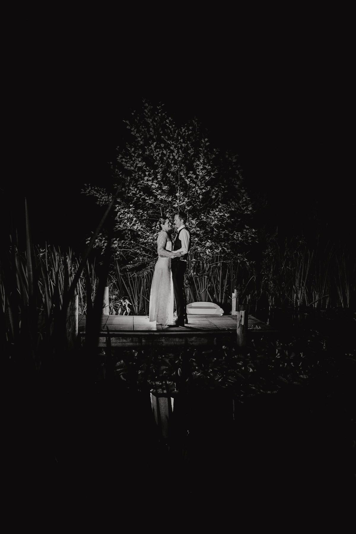 Night backlit creative photos of bride and groom in bridgewater country estate gardens after wedding reception. Venue in Kaukapakapa, Auckland photo by sarah weber photography