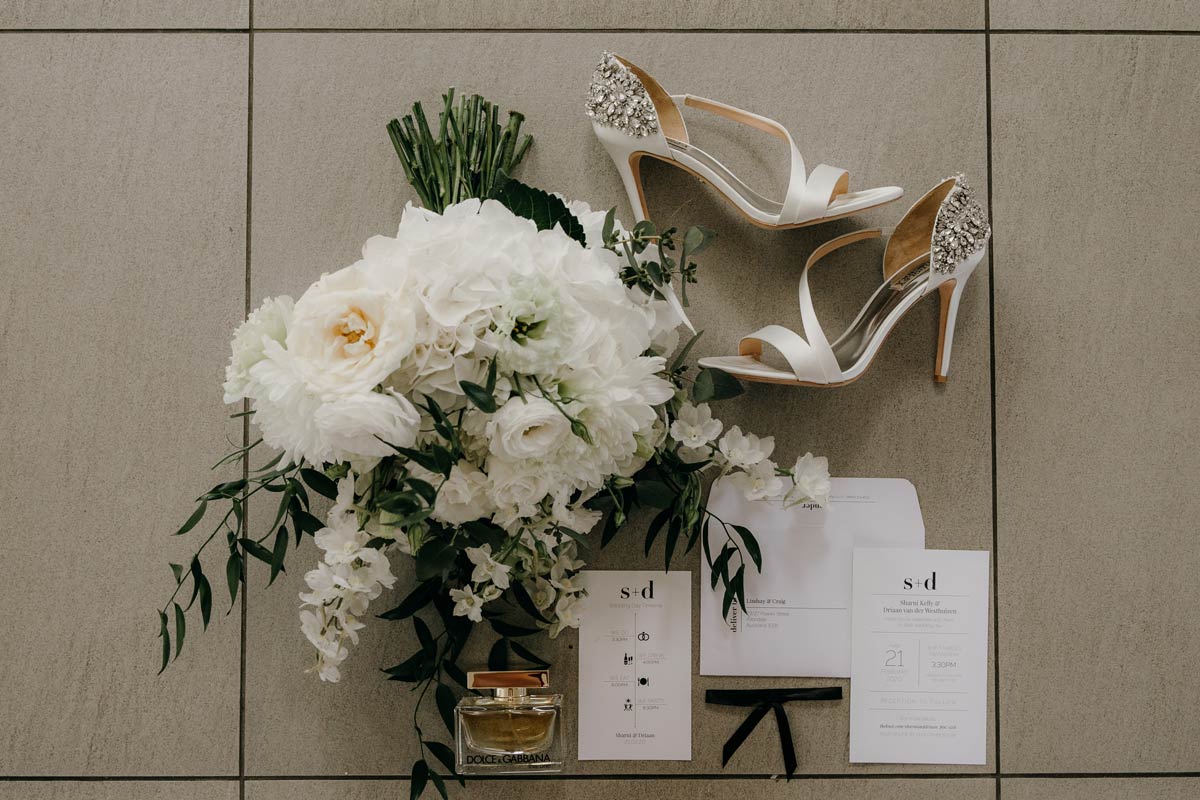 bride details of flowers, shoes, purfume, stationery at the dunes, omaha lodge before the stables matakana wedding photos by sarah weber photography