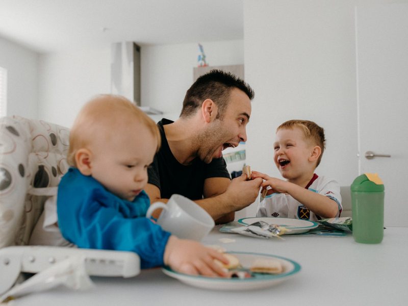 kiwi dad feeding children at dinner table photo by sarah weber photography