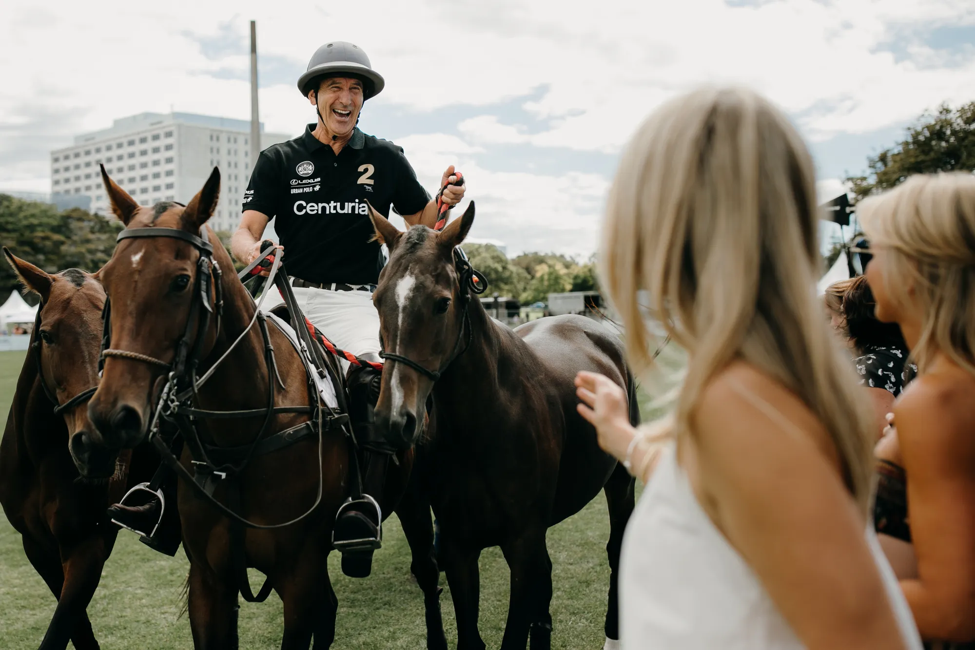 Polo player laughing with guests at Lexus Urban Polo, photo by Sarah Weber Photography